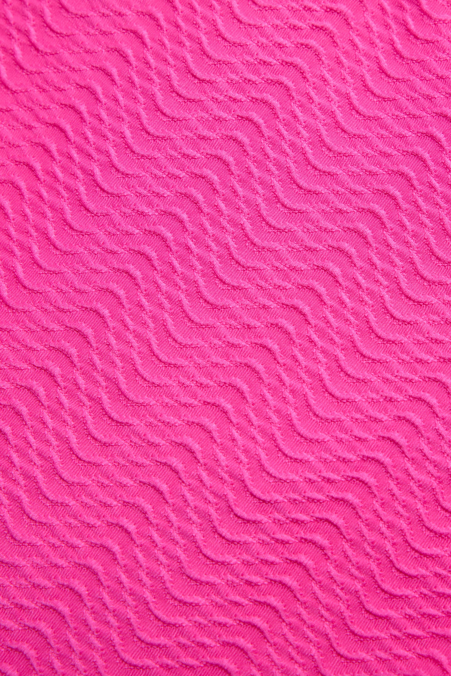 Top bikini testurizzato con dettagli a fiocco fucsia